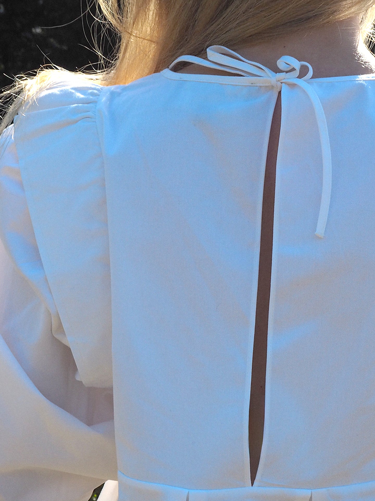 White Panel Blouse with thin straps and a cutout design on the back with. delicate ribbon closure.