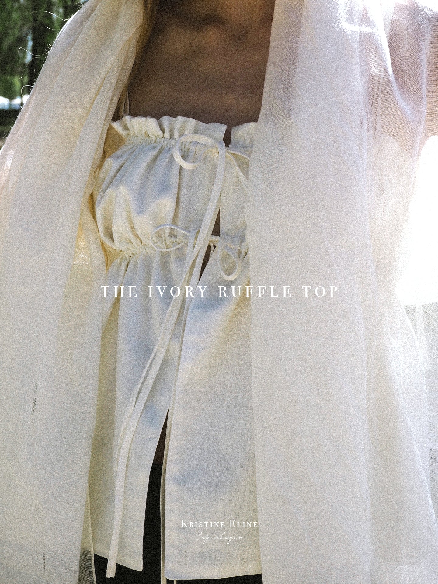 Ivory ruffle top with a blurred background